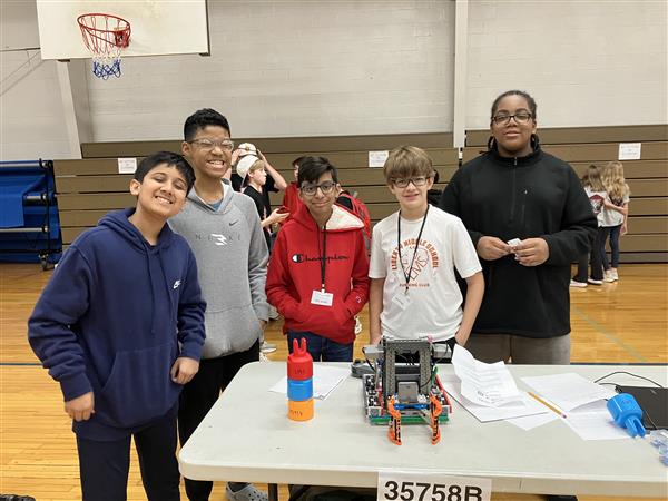 Students pose with their robot.